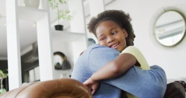 african american father and daughter talking and playing. Enjoying quality family time together at home.