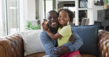 african american father and daughter talking and playing. Enjoying quality family time together at home.