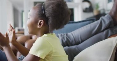 african american father and daughter talking and playing. Enjoying quality family time together at home.