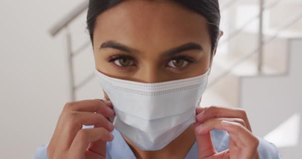 Video Biracial Female Doctor Putting Face Mask Looking Camera Health — Video Stock
