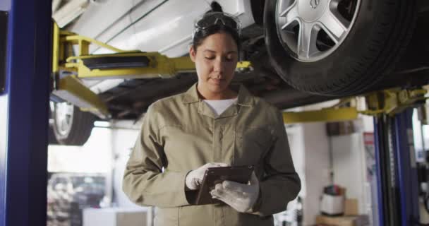 Video Biracial Female Car Mechanic Using Tablet Looking Camera Working — Wideo stockowe