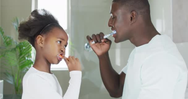 African American Father Daughter Brushing Teeth Enjoying Quality Family Time — Stockvideo