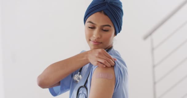 Video Happy Biracial Female Doctor Hijab Showing Plaster Vaccination Health — Vídeo de stock