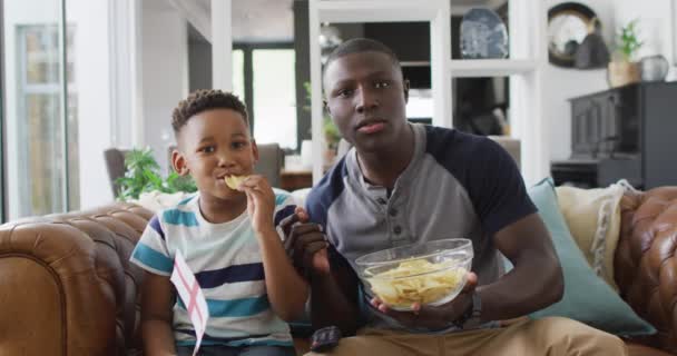 Video Happy African American Father Son Sitting Sofa Watching Match — Wideo stockowe