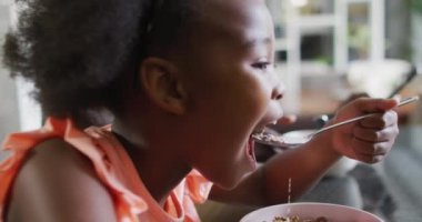african american father and daughter preparing breakfast. Enjoying quality family time together at home.