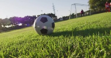 Video of diverse group of male football players playing football. Male football team, inclusivity and fitness in team sports.