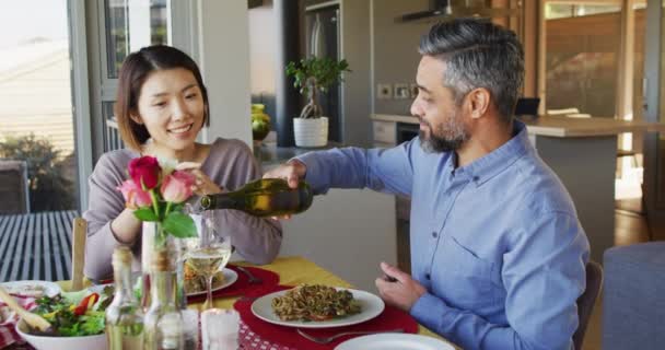 Happy Diverse Couple Sitting Table Dining Room Eating Dinner Drinking — Stockvideo