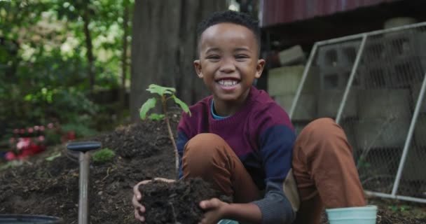 Portrait Happy African American Boy Holding Plant Garden Spending Time — Stockvideo