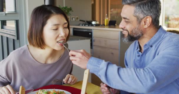 Happy Diverse Couple Sitting Table Dining Room Eating Dinner Spending — Stockvideo