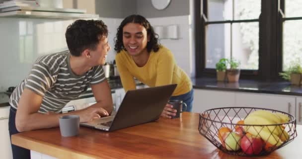 Happy Diverse Male Couple Drinking Coffee Using Laptop Kitchen Spending — Video Stock
