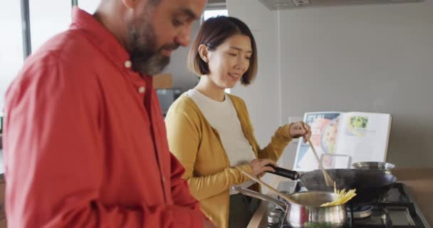 Happy Diverse Couple Cooking Together Mixing Ingredients Pan Kitchen Spending — Stockvideo