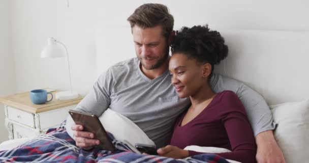 Video Happy Diverse Couple Using Tablet Bed Talking Love Relationship — Stock video