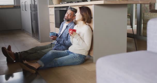 Happy Diverse Couple Sitting Kitchen Drinking Coffee Talking Spending Quality — Stockvideo