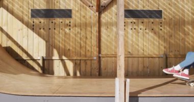 Video of happy diverse female and male skateboarders having fun in skate park. Skateboarding, sport, active lifestyle and hobby concept.