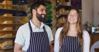 Video of happy diverse female and male sellers with tablet in skate shop. Skateboarding, sport, hobby and skate shop concept.
