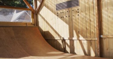 Video of caucasian male skateboarder training in skate park. Skateboarding, sport, active lifestyle and hobby concept.