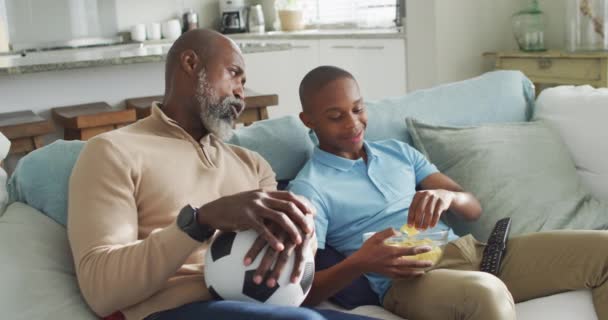 Video Happy African American Father Son Eating Chips Watching Together — Stock Video