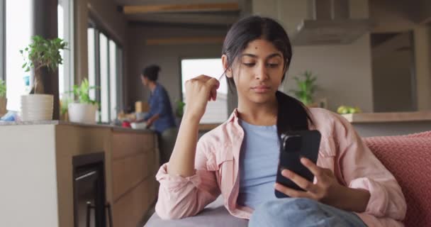 Video Thoughtful Biracial Woman Sitting Sofa Using Smartphone Relax Leisure — Video