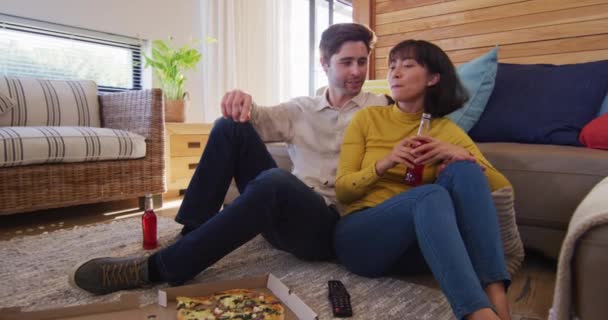 Video Happy Diverse Couple Drinking Beer Talking Living Room Love — Stockvideo
