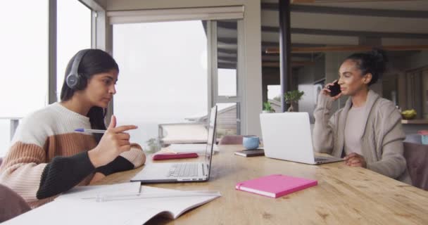 Video Focused Biracial Women Working Home Laptop Smartphone Friendship Working — Stockvideo