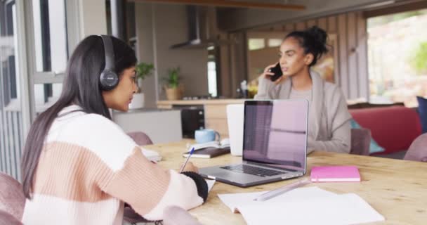 Video Focused Biracial Women Working Home Laptop Smartphone Friendship Working — Stockvideo