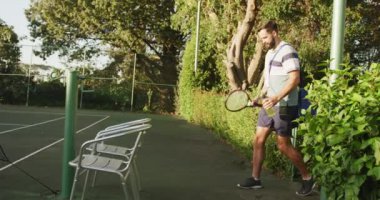 Video of happy caucasian man entering the court. Healthy active lifestyle and fitness at home.