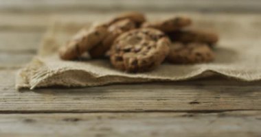 Video of biscuits with chocolate on wooden background. cookies,bake, food, candy, snacks and sweets concept.