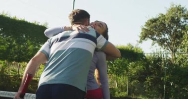 Video of happy caucasian couple shaking hands on the court. Healthy active lifestyle and fitness at home.