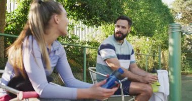 Video of happy caucasian couple on having break the court. Healthy active lifestyle and fitness at home.