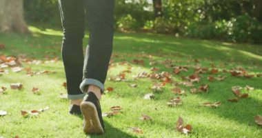 Video of happy caucasian warmly man dressed spending in the garden. Domestic lifestyle and leisure time in the garden.