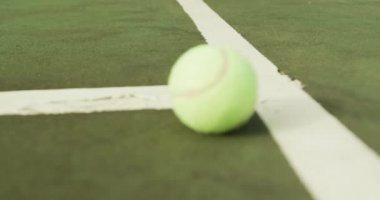 Video of one green tennis ball on the green court. Healthy active lifestyle and tennis.