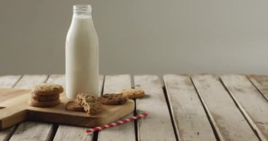 Video of biscuits with chocolate and milk on wooden background. cookies,bake, food, candy, snacks and sweets concept.