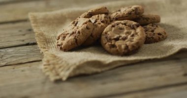 Video of biscuits with chocolate on wooden background. cookies,bake, food, candy, snacks and sweets concept.