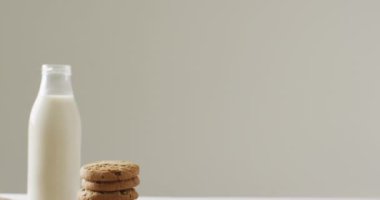 Video of biscuits with chocolate and milk on white background. cookies,bake, food, candy, snacks and sweets concept.