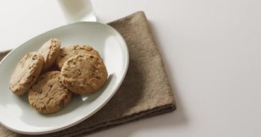 Video of biscuits with chocolate and milk on white background. cookies,bake, food, candy, snacks and sweets concept.