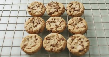 Video of rows biscuits on a baking rack over white background. cookies,bake, food, candy, snacks and sweets concept.