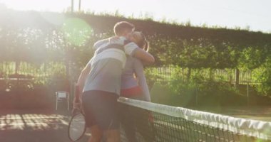 Video of happy caucasian woman playing tennis on the court. Healthy active lifestyle and fitness at home.