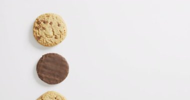 Video of biscuits with chocolate over white background. cookies,bake, food, candy, snacks and sweets concept.