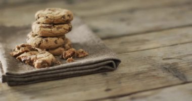 Video of biscuits with chocolate on wooden background. cookies,bake, food, candy, snacks and sweets concept.