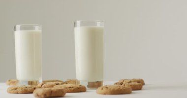 Video of biscuits with chocolate and milk on white background. cookies,bake, food, candy, snacks and sweets concept.