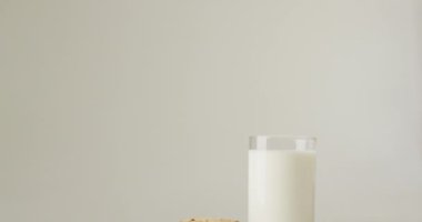 Video of biscuits with chocolate and milk on white background. cookies,bake, food, candy, snacks and sweets concept.