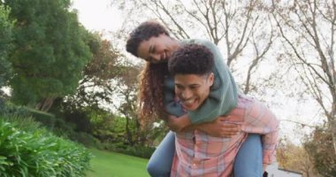Video of happy biracial couple spending time in the garden. Domestic lifestyle and leisure time in the garden.