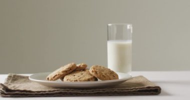 Video of biscuits with chocolate and milk on white background. cookies,bake, food, candy, snacks and sweets concept.