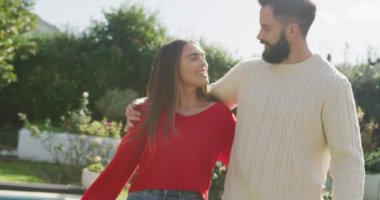 Video of happy caucasian couple spending time in the garden. Domestic lifestyle and leisure at home.