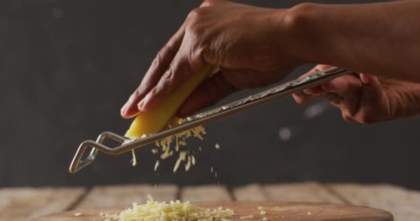 Video Close Hands African American Man Grating Cheese Wooden Board — Video Stock
