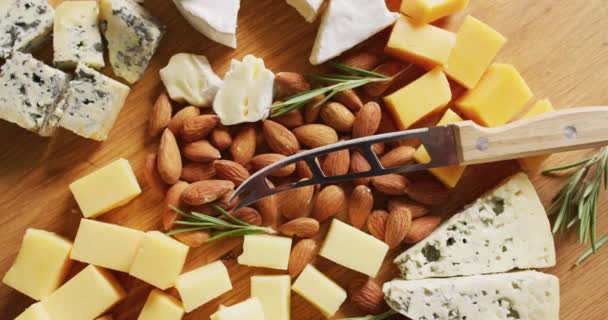 Video Assorted Hard Soft Cheeses Nuts Rosemary Knife Wooden Board — Vídeos de Stock