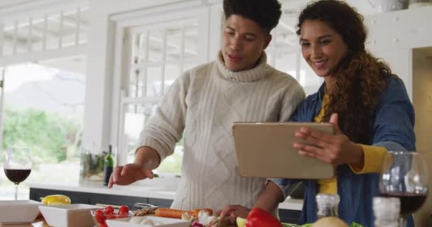Video Happy Biracial Couple Preparing Meal Together Using Tablet Domestic — Wideo stockowe