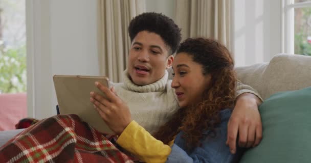 Video Happy Biracial Couple Siting Sofa Blanket Using Tablet Domestic — Stockvideo
