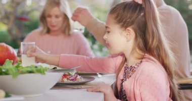 Video of happy caucasian daughter turning and laughing at outdoor family dinner table. Family, domestic life and togetherness concept digitally generated video.
