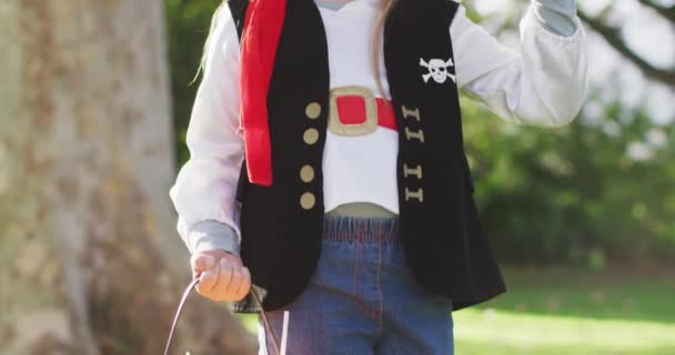 Video Happy Caucasian Girl Pirate Costume Holding Halloween Trick Treat — Stockvideo